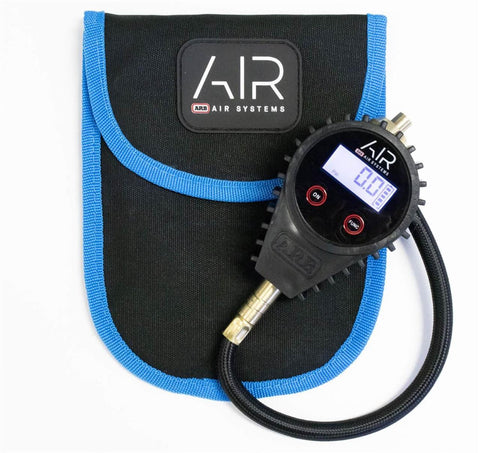 ARB510 E-Z digital tire deflator with a black rubber armored head, backlit LCD showing 0.0 psi, red ON and FUNC buttons and a short black braided line, shown beside the black ARB Air Systems carry pouch