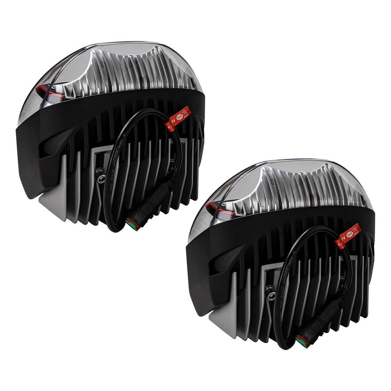 Rear three-quarter view of the ARB Intensity IQ pair showing the deeply finned black heatsinks, the sealed connector pigtails and the red 9 to 32V DC labels on the leads