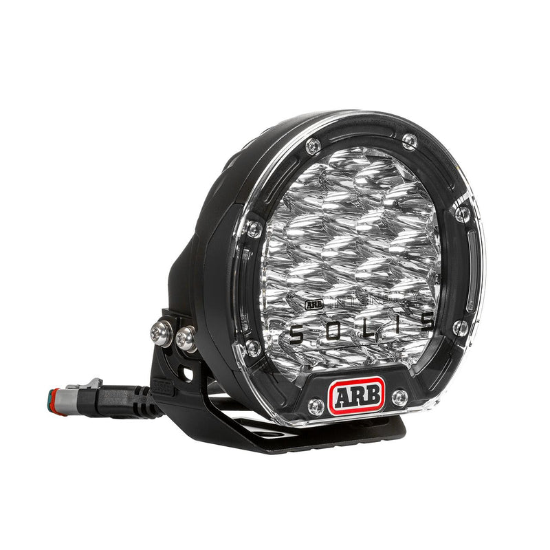 ARB Intensity SOLIS LED driving light with black bezel inserts, front three-quarter view on white