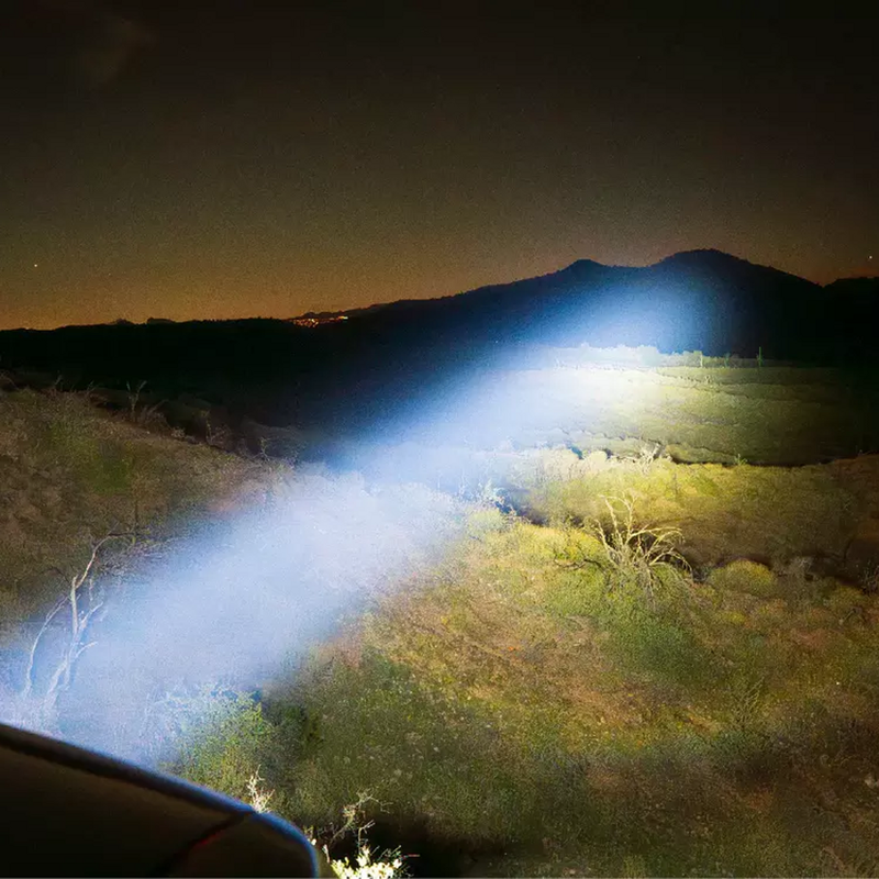 NACHO driving light beam lighting a desert hillside at night
