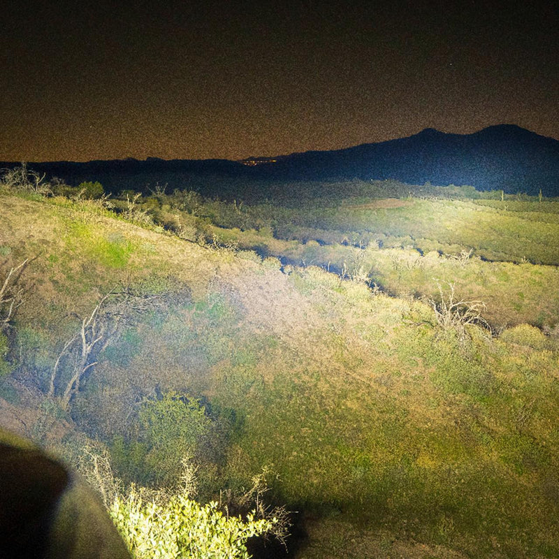 NACHO driving light beam lighting a desert hillside at night