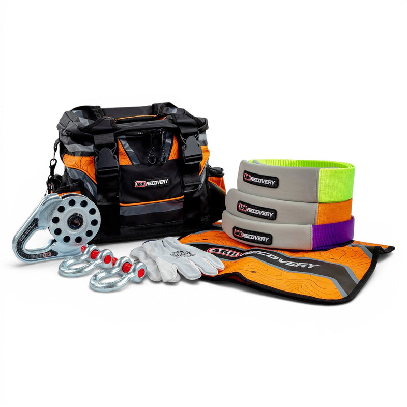 ARB Premium Recovery Kit laid out: large recovery bag with snatch strap, tree trunk protector, winch extension strap, snatch block, shackles and gloves