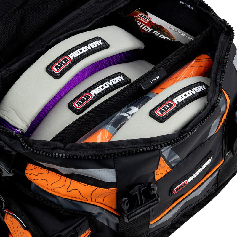 ARB Premium Recovery Kit laid out: large recovery bag with snatch strap, tree trunk protector, winch extension strap, snatch block, shackles and gloves, alternate angle