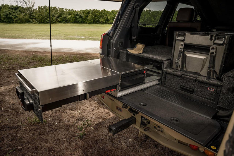ARB Slide Out Camp Kitchen RDKNA1045 slid out on its rails with the lid closed as a stainless bench, mounted in an ARB drawer system