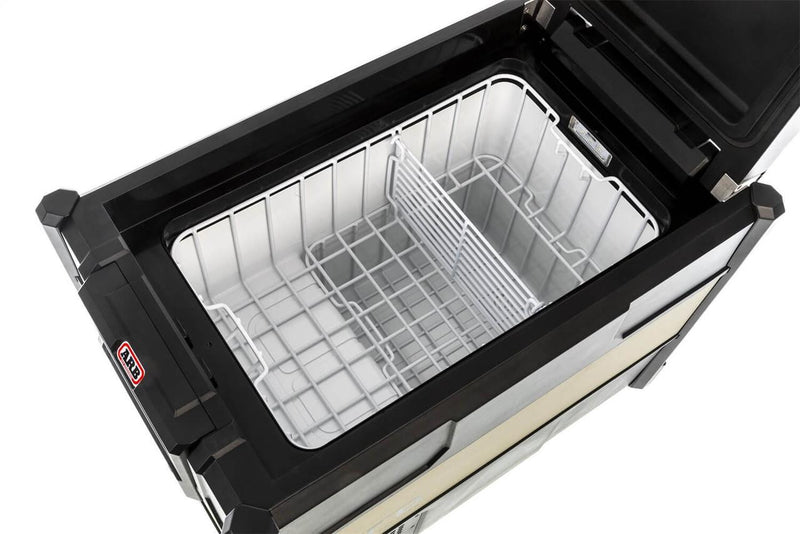 Overhead interior view of the ARB ZERO 47 qt fridge freezer showing the white wire basket, the removable divider and the LED interior light