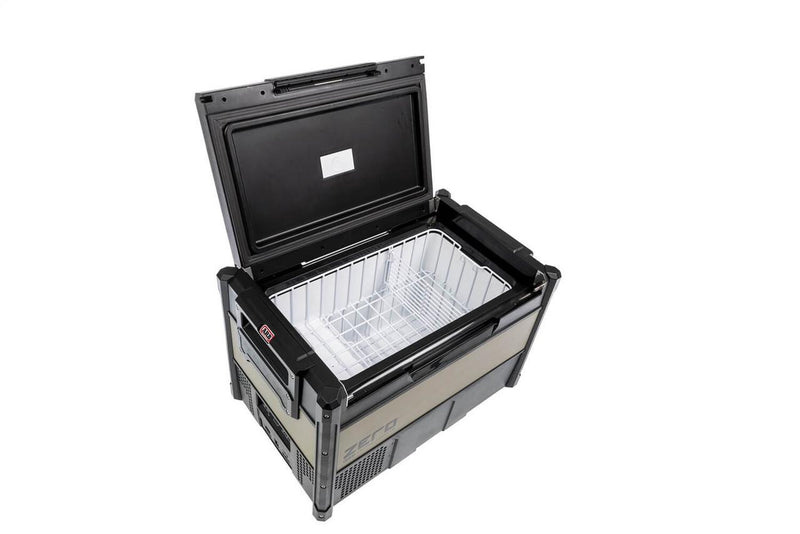 Interior of the ARB ZERO 63 qt fridge freezer with the lid open, showing the full width wire basket and divider against the white cabinet lining