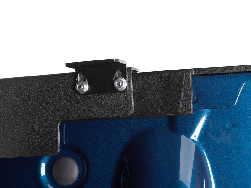 Close-up of the textured perimeter edge of the LUX lid and one mounting bracket below it.