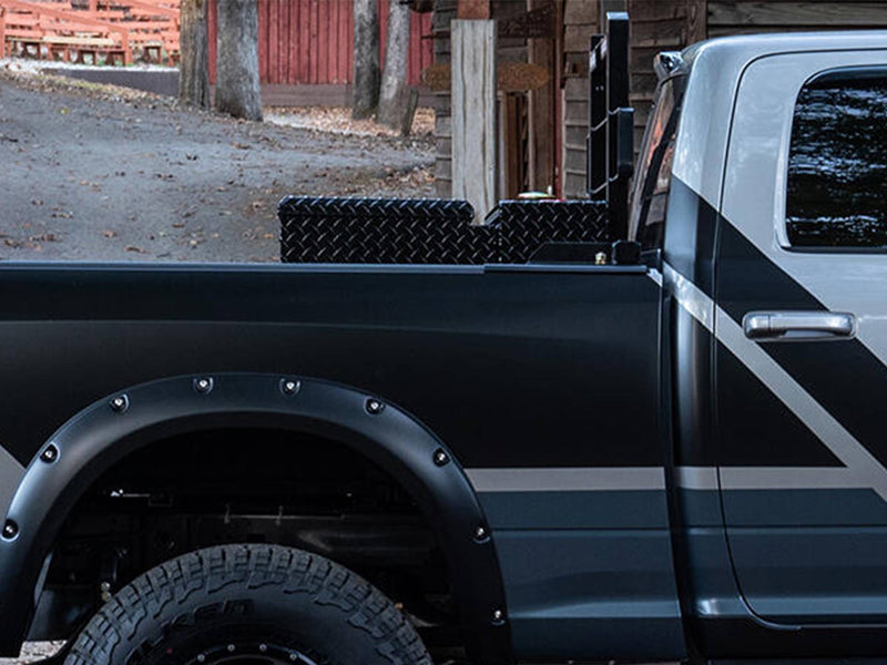 BackRack Crossover Toolbox: side view of a two-tone pickup bed with a black diamond plate toolbox and a rack partly visible behind the cab
