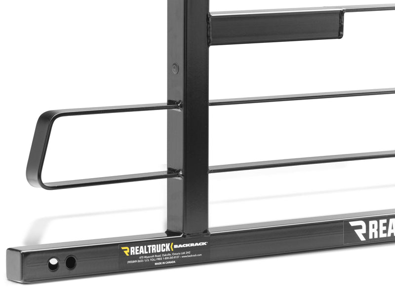 BackRack Original Short: close-up of a black headache rack upright, grab handle and base rail with the RealTruck BackRack label