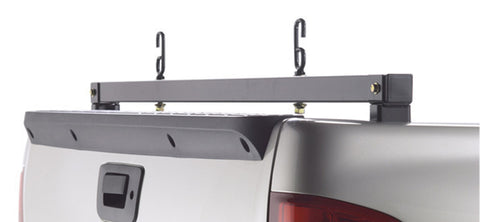 BackRack Rear Bar: A black rear ladder bar with two J hooks bolted across the rear of a silver pickup bed above the tailgate cap and handle