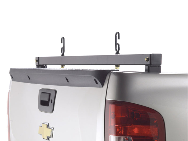 BackRack Rear Bar: black rear ladder bar with two J hooks mounted across the rear of a silver pickup bed