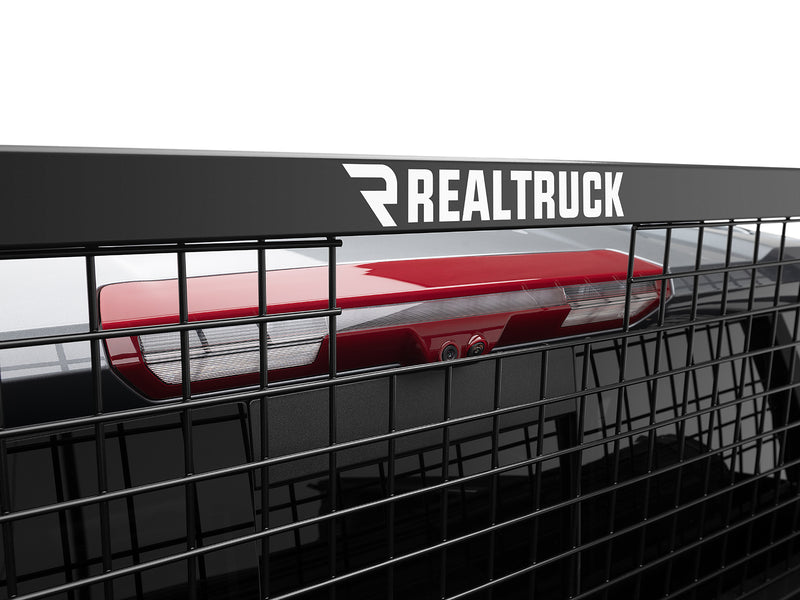 BackRack Safety: close-up of a black Safety headache rack top bar with RealTruck lettering and the welded wire mesh screen