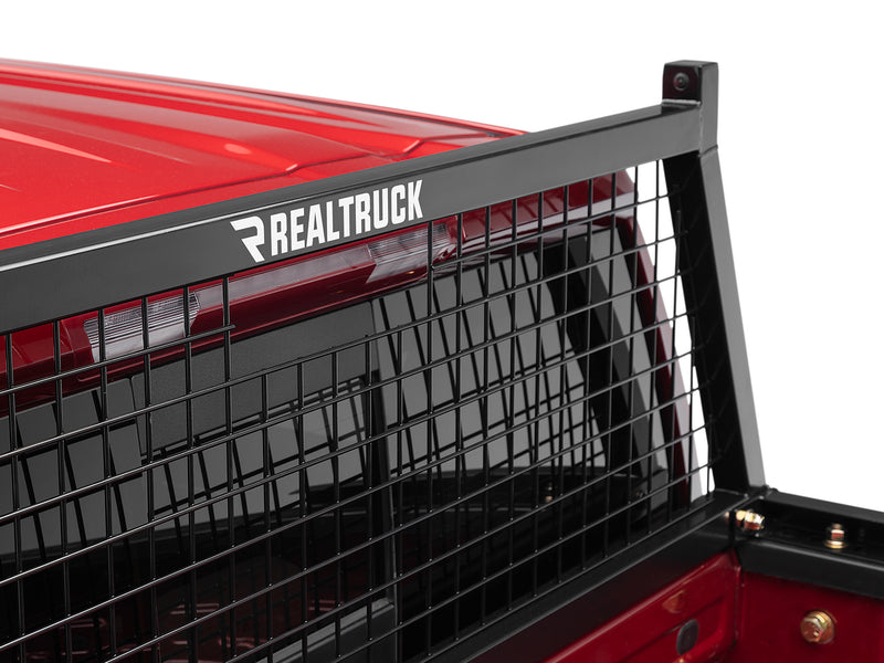 BackRack Safety: close-up of a black Safety headache rack with RealTruck lettering mounted behind the cab of a red pickup