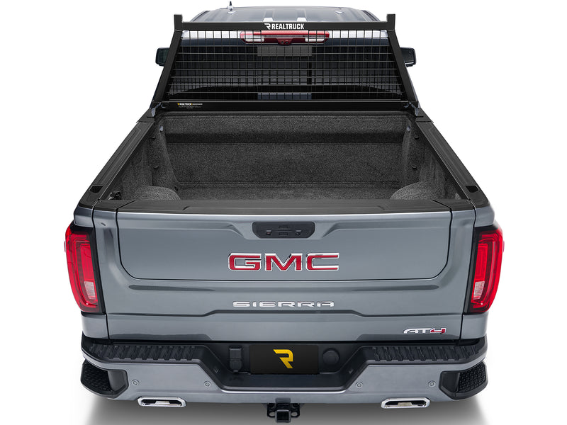 BackRack Safety: rear view of a gray pickup with a black Safety headache rack behind the cab and an empty carpeted bed