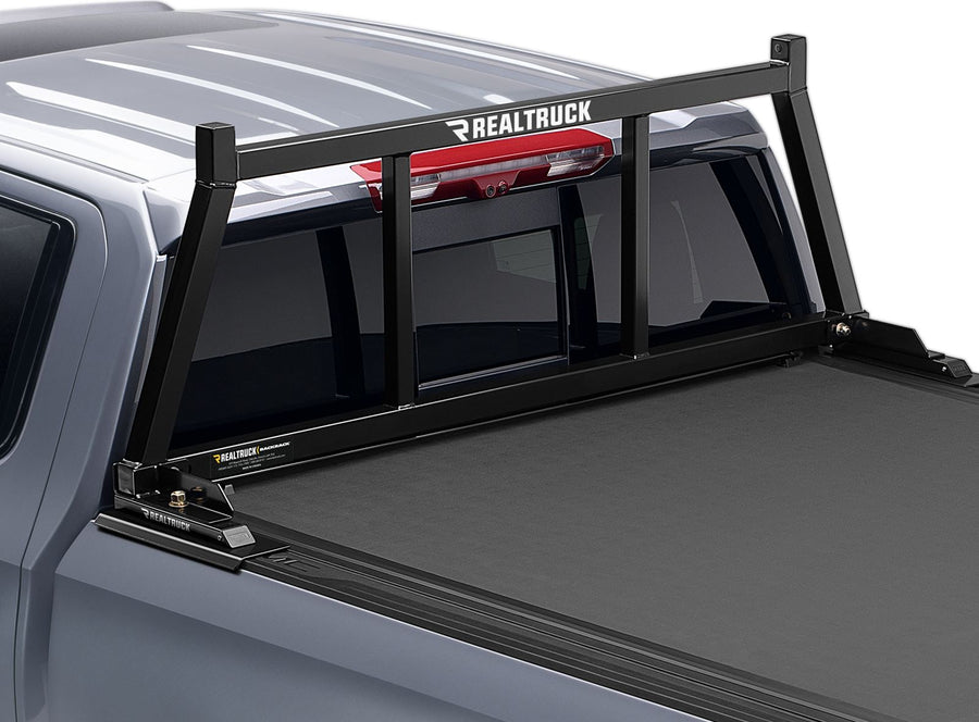 BackRack Open Headache Rack: A black open headache rack is mounted behind the cab of a gray GM pickup with a tonneau cover.