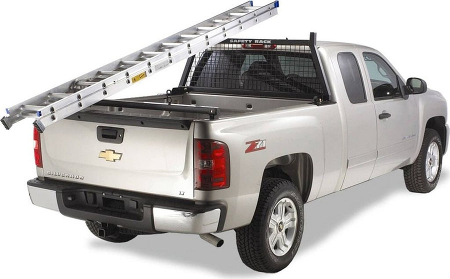 BackRack Rear Bar: Silver pickup with an extension ladder resting on a black Safety headache rack and a rear ladder bar at the tailgate.