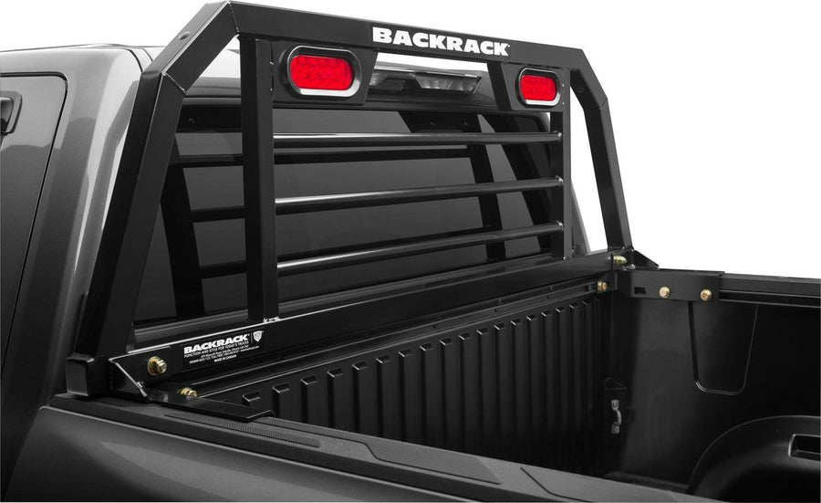 BackRack SRL Headache Rack with Lights: A black SRL headache rack with red oval lights installed at the front of a dark pickup bed.