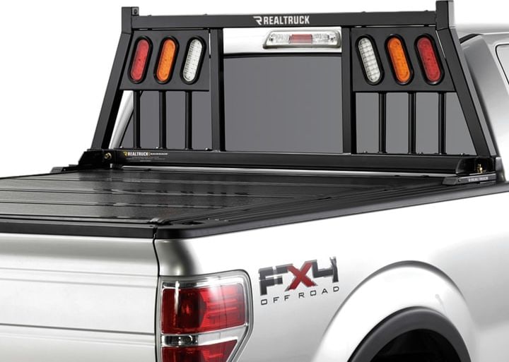 BackRack Three Light Headache Rack: A black headache rack with red, amber and clear oval lights in each side panel on a silver pickup with a hard folding tonneau cover.