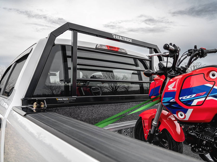 BackRack SR Headache Rack: A black SR headache rack mounted behind the cab of a white pickup with a red pickup minibike strapped in the bed.