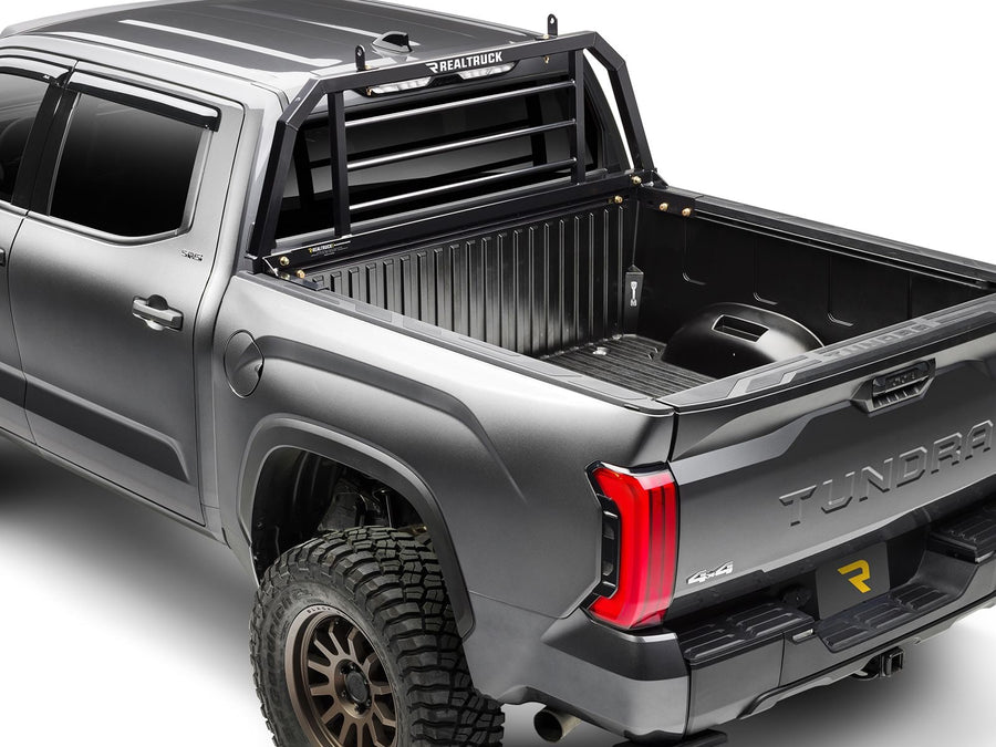 BackRack SR Headache Rack: A black SR headache rack mounted behind the cab of a gray pickup with an open bed.