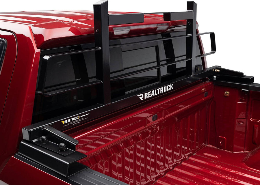 BackRack Original Short Headache Rack: Black Original style headache rack on raised tonneau adapter brackets behind the cab of a red pickup.