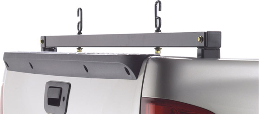 BackRack Rear Bar: A black rear ladder bar with two J hooks bolted across the rear of a silver pickup bed above the tailgate cap and handle.