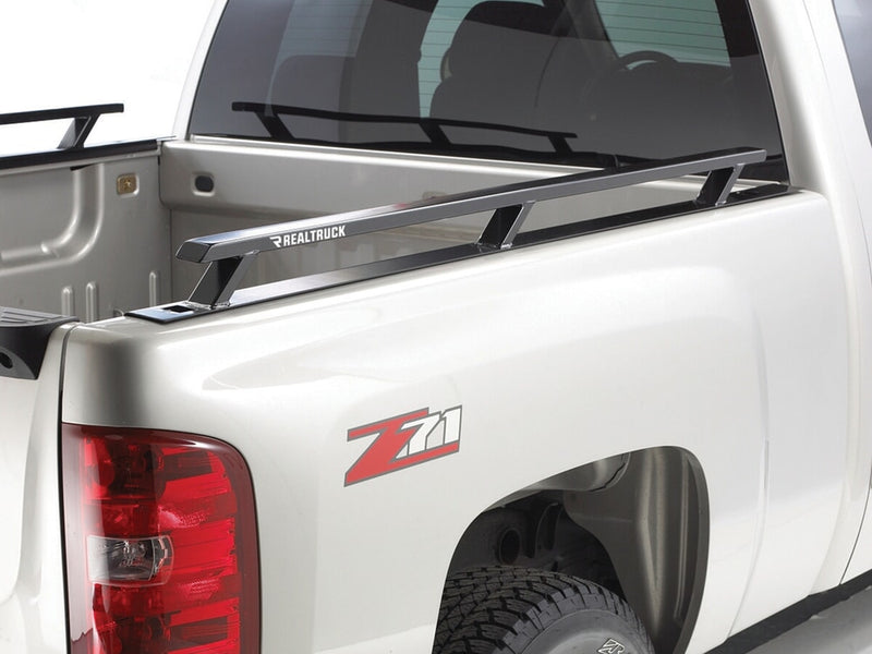 BackRack Side Rails: black bed side rails mounted along the bed of a white pickup