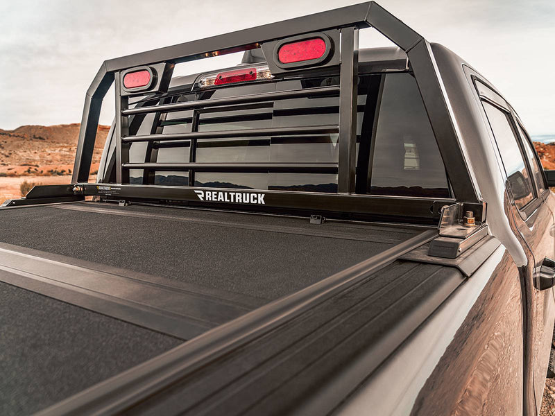 BackRack SRL: A black SRL headache rack with red oval lights stands behind a dark truck cab above a hard folding tonneau cover