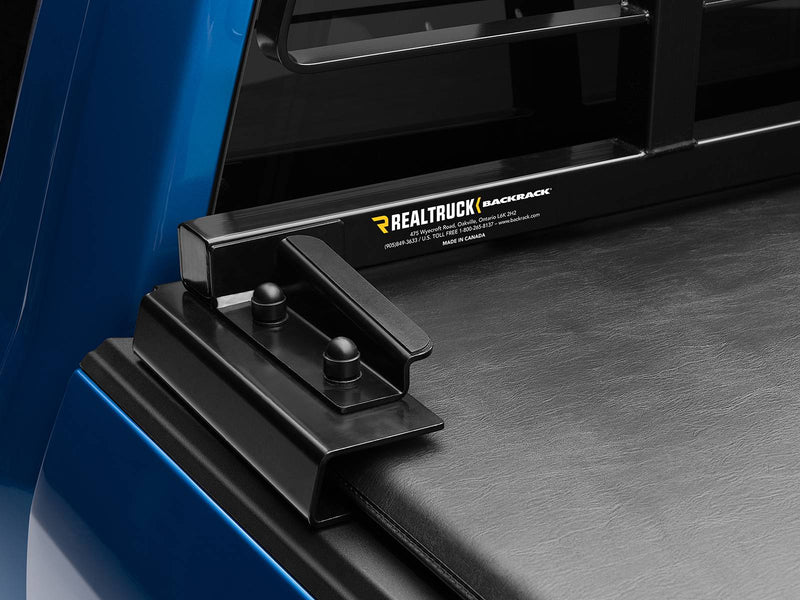 BackRack Tonneau Adapter: black tonneau adapter bracket with two capped studs holding a rack above a soft tonneau cover on a blue truck