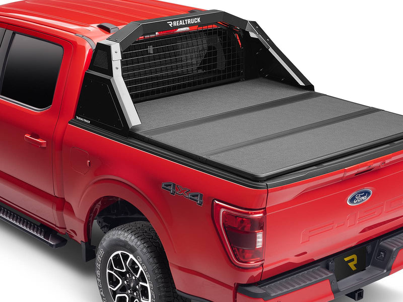 BackRack Trace Rack: A red Ford F-150 with a black Trace Rack behind the cab and a hard folding tonneau cover