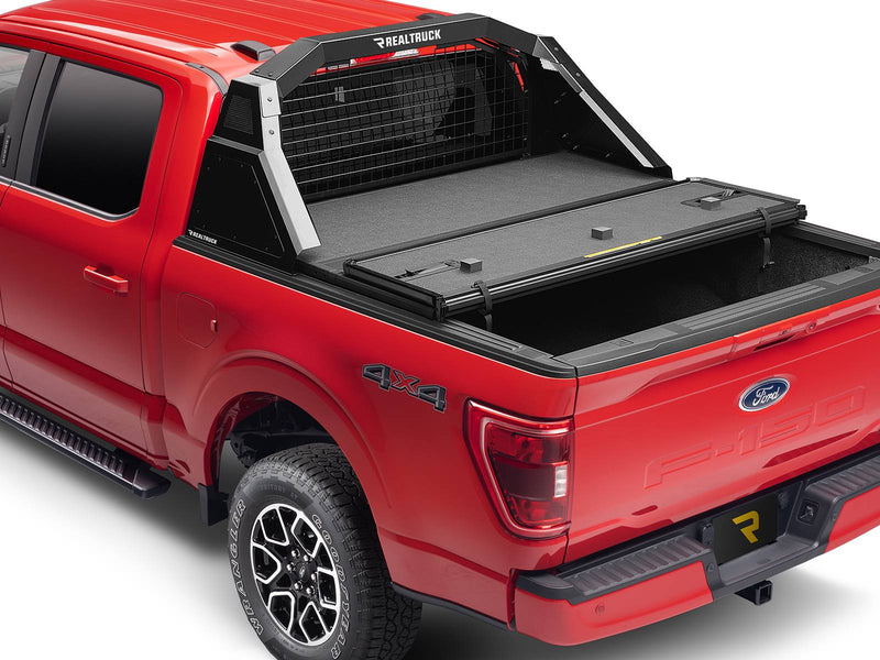 BackRack Trace Rack: A red Ford F-150 with a black Trace Rack and a hard folding tonneau cover half open