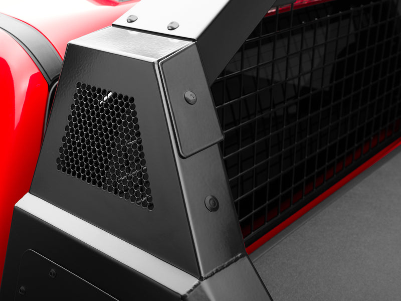 BackRack Trace Rack: close-up of a black Trace Rack side box with a perforated vent panel and wire mesh on a red pickup