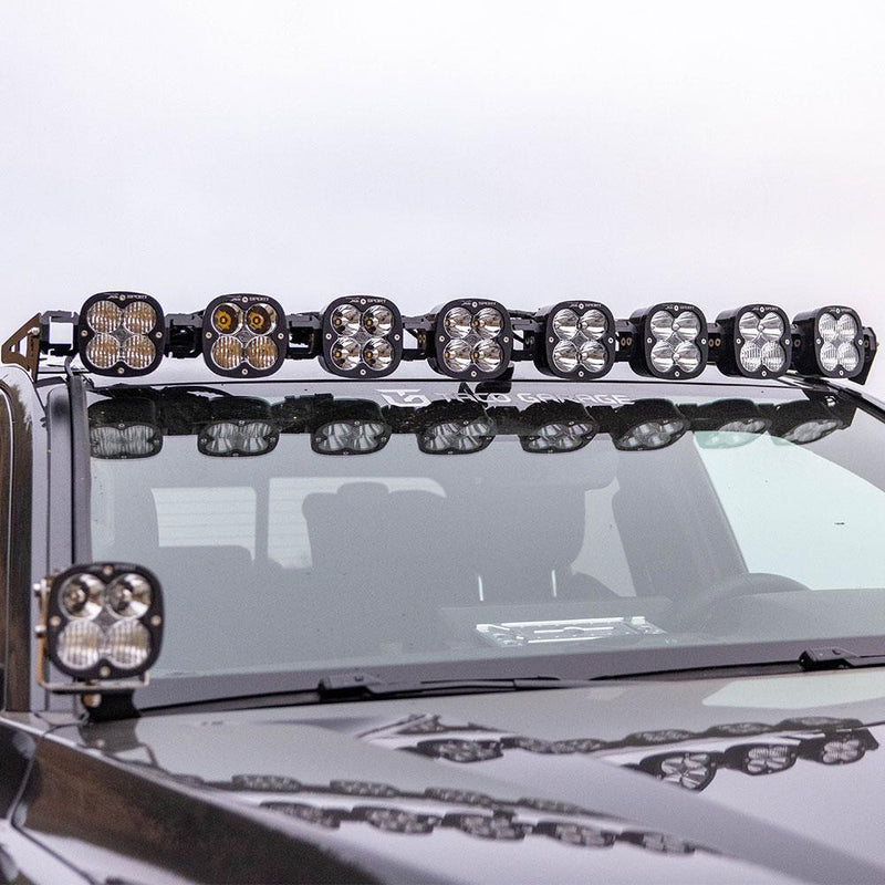 Baja Designs 8XL Linkable Roof Kit on a vehicle: A linkable LED pod bar sits across the roof of a gray truck with a matching pod on the A-pillar