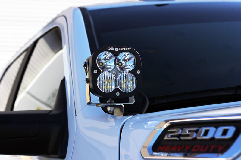Baja Designs XL Sport A-Pillar Light Kit mounted at the windshield of a Ram 2500 Heavy Duty