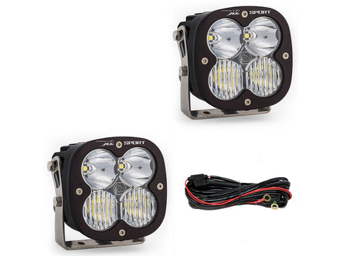 Baja Designs XL Sport Bumper Light Kit, complete kit on a studio background: two black XL Sport pods with clear lenses and a relay wiring harness on white
