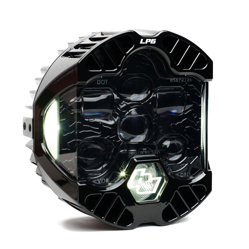 Baja Designs DOT LP6 LED Headlight Replacement, whole product on a studio background: A single LP6 LED headlight with a clear lens and white accent light glowing, on white