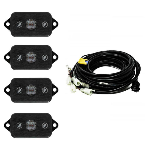 Baja Designs LED Rock Light Kit, complete kit on a studio background: four black LED rock light pods with red centers shown with a coiled multi-lead wiring harness on white