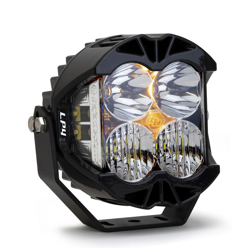 Baja Designs LP4 Pro LED Auxiliary Light Pod, whole product on a studio background: A black LP4 Pro LED pod with clear lenses and a small amber backlight glow, angled on a white background