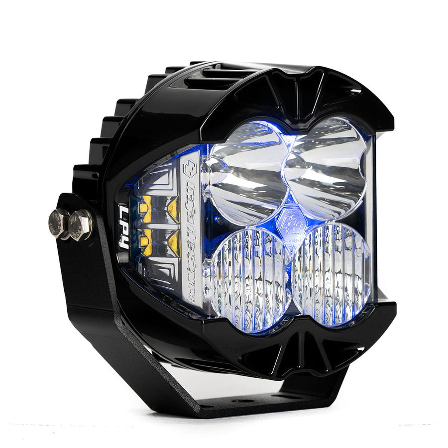 Baja Designs LP4 Pro LED Auxiliary Light Pod, whole product on a studio background: A black LP4 Pro LED pod with clear lenses and a blue colored backlight glowing, shown at an angle on white