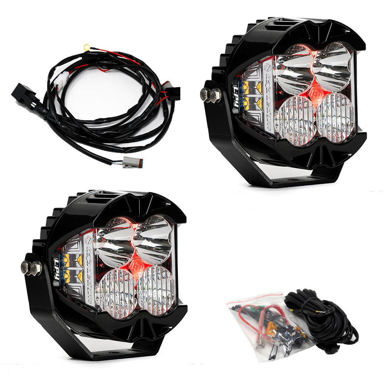 Baja Designs LP4 Pro LED Auxiliary Light Pod Pair, whole product on a studio background: A pair of LP4 Pro LED pods with clear lenses and red backlights glowing, with a wiring harness and hardware bag on white