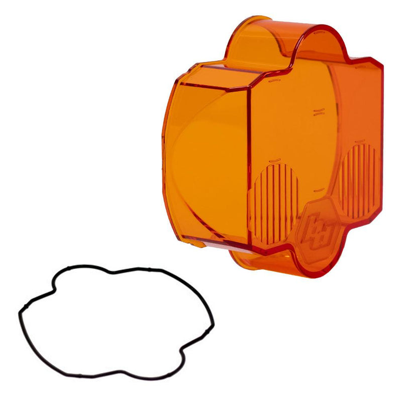 Baja Designs LP6 Light Pod Lens Kit, complete kit on a studio background: A orange LP6 replacement lens cover with wide cornering optics and a black rubber gasket on a white background