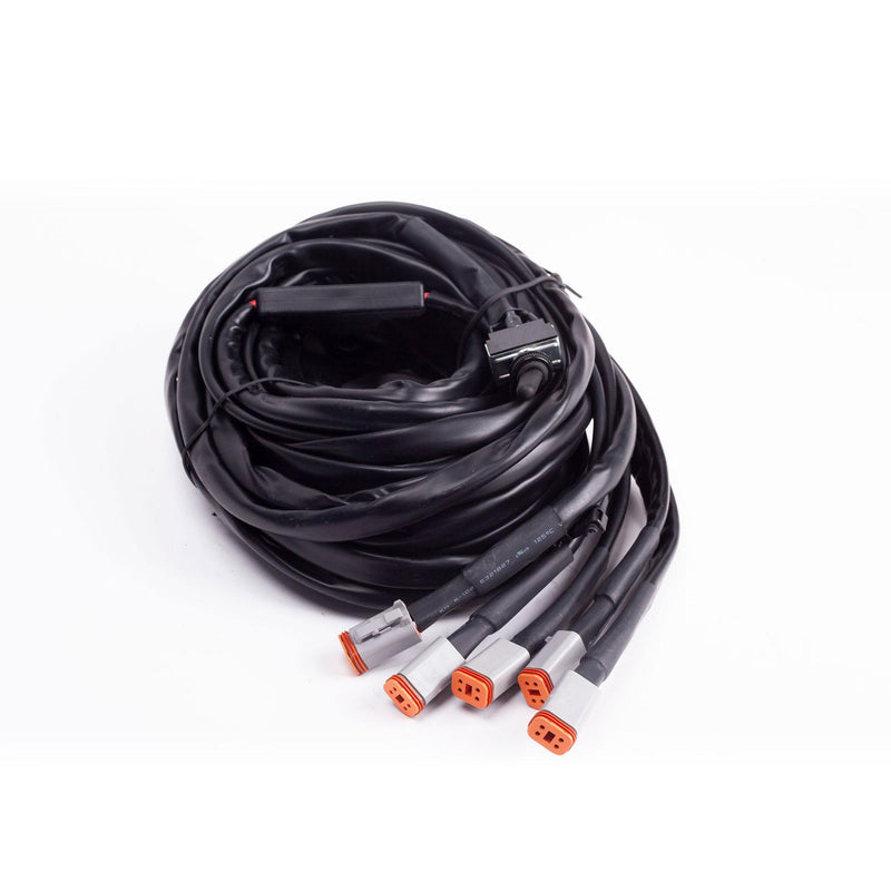 Baja Designs LP6, LP4 Wiring Harness, whole product on a studio background: A coiled wiring harness with five gray Deutsch connectors and a switch on white