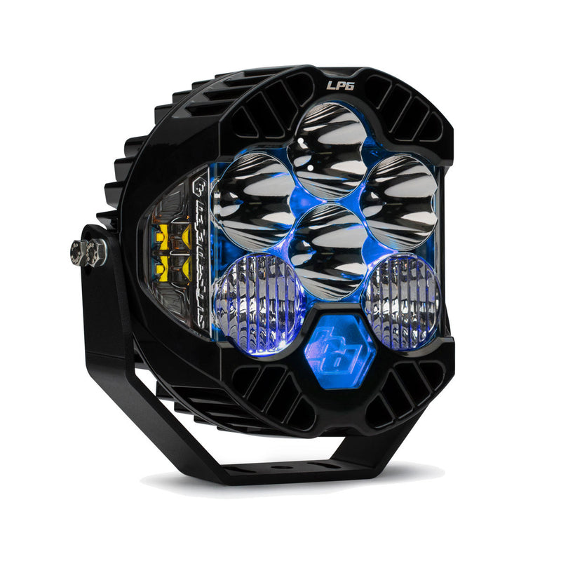 Baja Designs LP6 Pro LED Auxiliary Light Pod, whole product on a studio background: A black LP6 Pro LED pod with clear driving combo lenses and a blue colored backlight glowing, angled on white
