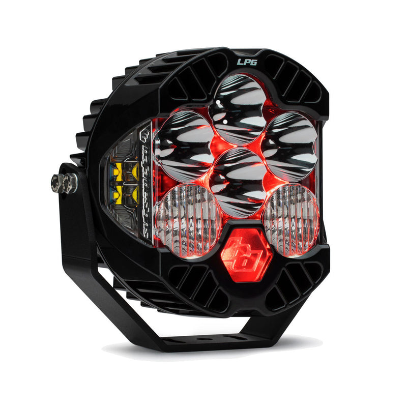 Baja Designs LP6 Pro LED Auxiliary Light Pod, whole product on a studio background: A black LP6 Pro LED pod with clear lenses and a red colored backlight glowing, angled on white