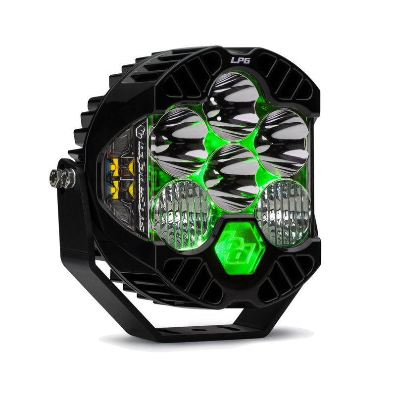 Baja Designs LP6 Pro LED Auxiliary Light Pod, whole product on a studio background: A black LP6 Pro LED pod with clear driving combo lenses and a green colored backlight glowing, angled on white