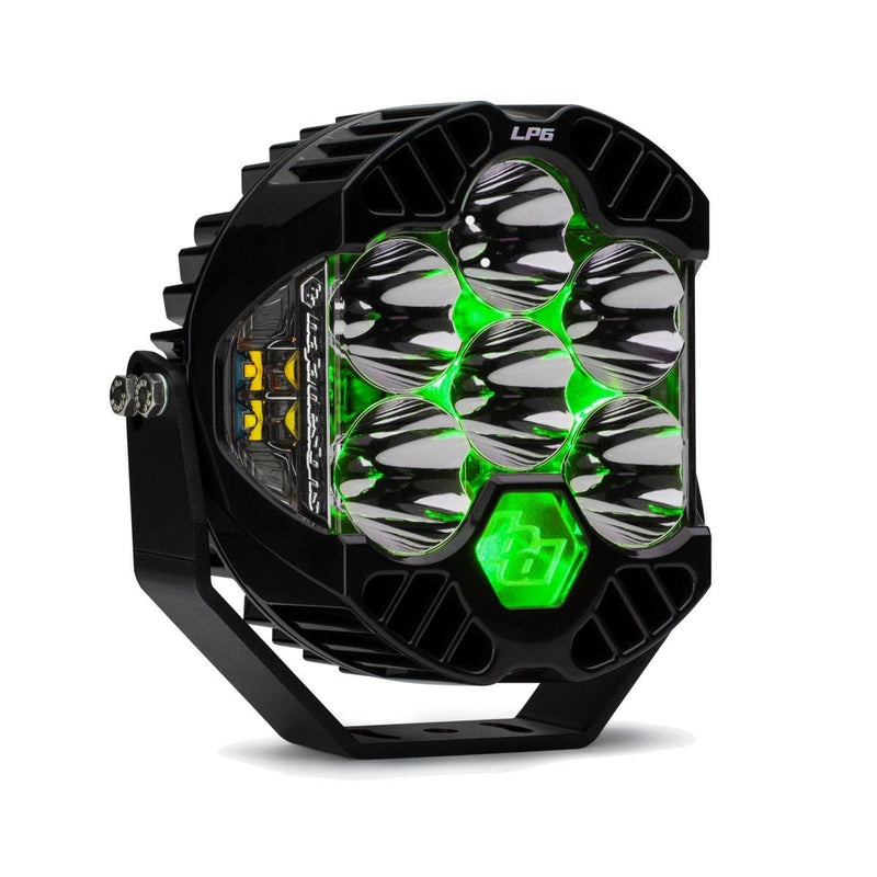 Baja Designs LP6 Pro LED Auxiliary Light Pod, whole product on a studio background: front three-quarter view of a single black LP6 Pro LED light pod clear lens, spot optics, green backlight glowing on its mounting bracket against a white background