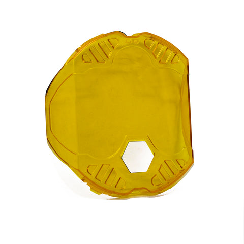 Baja Designs LP6 Single Rock Guard, whole product on a studio background: an amber translucent LP6 rock guard with a hex center opening on a white background