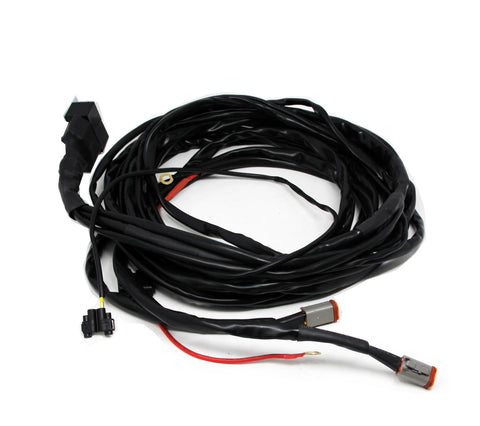 Baja Designs LP9/LP6 Series Upfitter Lock-Out Wiring Harness, whole product on a studio background: coiled black upfitter wiring harness with relay plug, red lead and two DT connectors on white