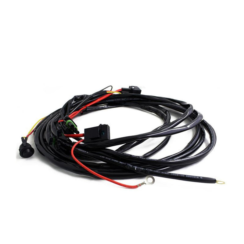 Baja Designs On/Off Wiring Harness, whole product on a studio background: coiled black wiring harness with relay, fuse holder, switch plug, red power lead and ring terminals on white