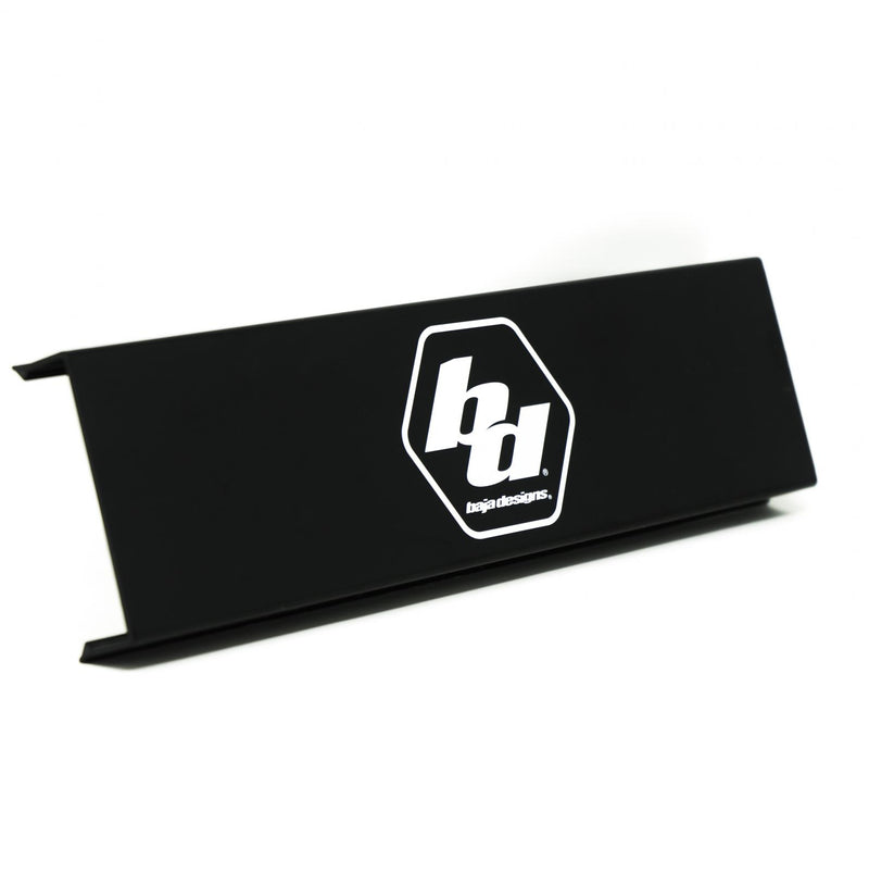 Baja Designs OnX6 Single Rock Guard, whole product on a studio background: A black long rectangular OnX6 rock guard with the white Baja Designs logo on a white background